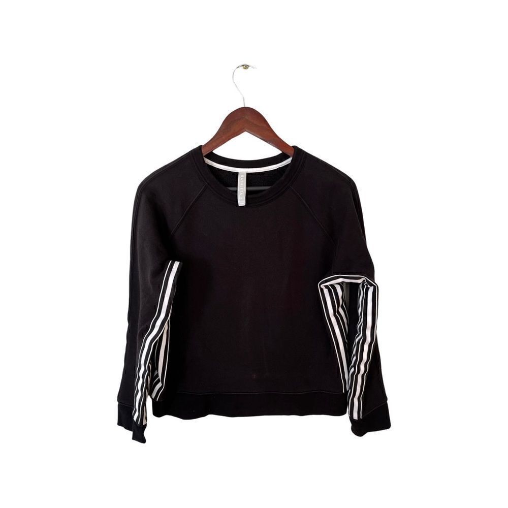 ATHLETA black crew neck sweatshirt with white inner arm stripe.
